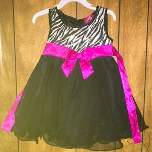 Zebra print dress with pink bow detail.